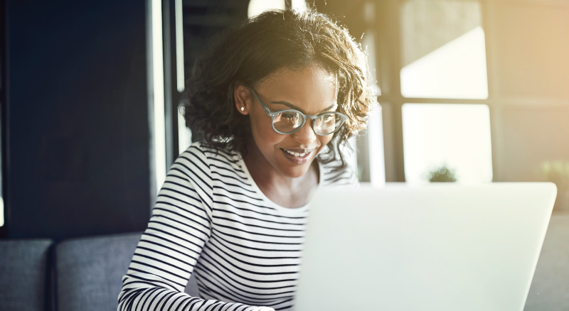 A person working on a laptop in a well-lit room