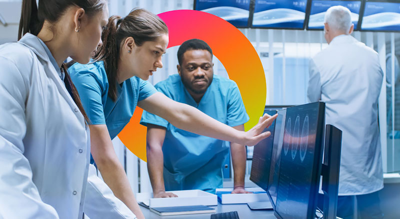 Medical professionals examine MRI scans in a lab