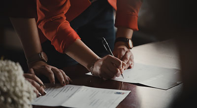 Pair of hands signs a contract