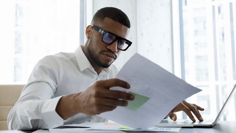 man reviewing paper documents