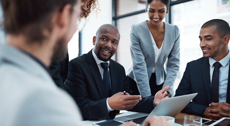 Man advises employees that surround him