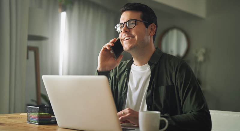 Man on cell phone and laptop