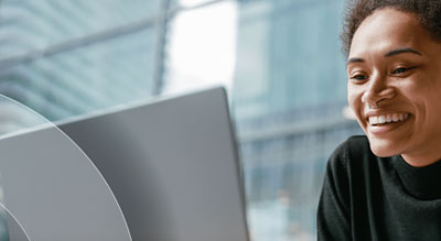 A person working on a laptop in a modern office setting