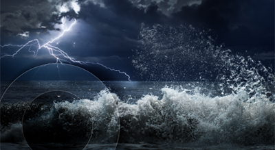 A stormy night scene featuring lightning illuminating crashing ocean waves