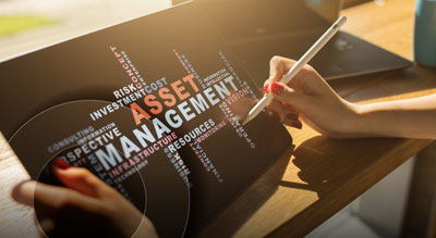 A person uses a pen on a tablet displaying text related to asset management