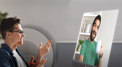 Two individuals engaging in a video call, with one person gesturing while speaking and the other listening attentively