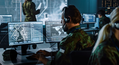 military operators working on computers inside federal operation room