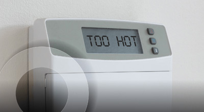 A thermostat indicating an overly warm temperature