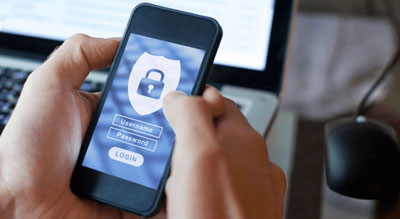 A person holding a smartphone with a security padlock on the screen, indicating a authentication process