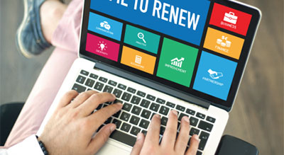  A person holding a laptop, browsing renewal options online
