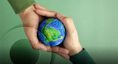 Symbolic image of unity and humanity portrayed by two hands holding an earth model