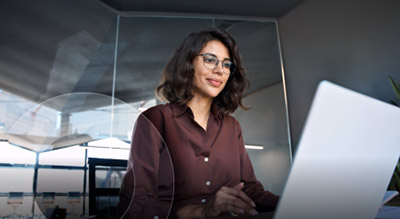 An employee working on a white laptop