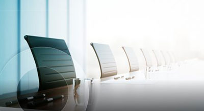 Two individuals in a café looking at a tablet with a document on the table