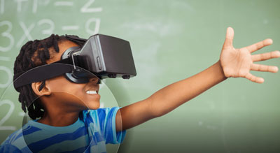 A child wearing a virtual reality headset reaches out as if interacting with something in a virtual environment, with a chalkboard filled with mathematical equations in the background