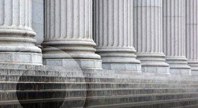 A close up of a staircase and the columns of a federal building