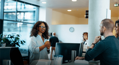 Employees chatting in an office setting