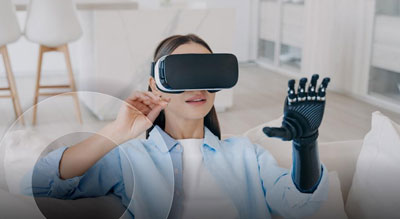 A person wearing a virtual reality headset and a glove with sensors, exploring the virtual environment while sitting on a sofa