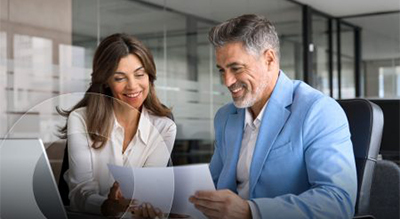 Two individuals analyzing documents in an office setting
