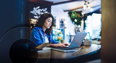 A person using a laptop in a cafe