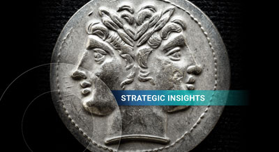 A detailed ancient coin featuring the embossed profile of two faces, set against a dark background with the text 'STRATEGIC INSIGHTS'