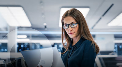 An individual operates a laptop inside a data center