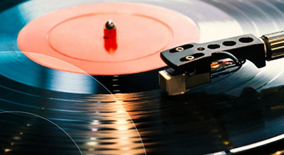 A close up of a vinyl record being played on a turntable