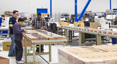 Workers assembling products on a production line in the SHI Integration Centers