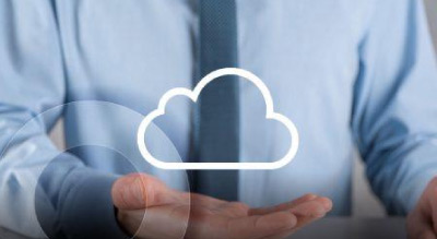 A person in a blue shirt and tie, holding a white cloud icon in their hand