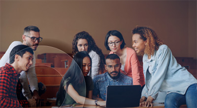 A group of employees looking at a laptop