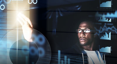 An individual interacting with a holographic interface against a dark background