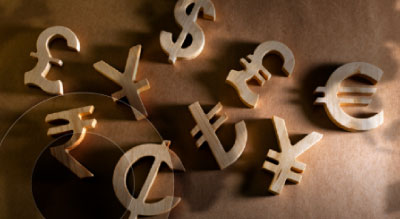 Wood blocks shaped like currency signs laying on the floor