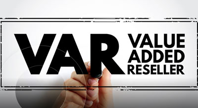 A hand writing 'VAR Value Added Reseller' on a transparent board