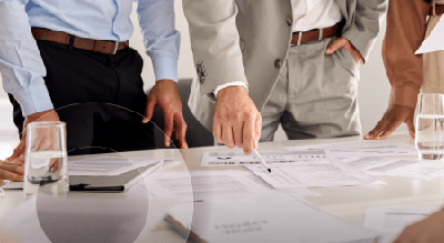 A diverse group of business professionals collaborating around a conference table, engaged in discussion and teamwork