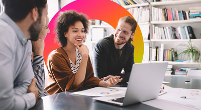 Four people engaged in a discussion in a modern office environment