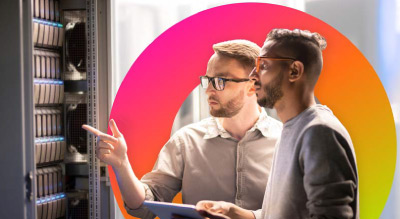 Two individuals discussing server configurations in front of a server rack