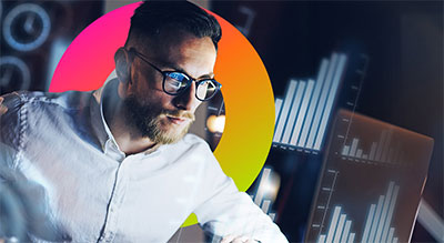 A person in a white shirt stands in front of colorful circular graphics and digital data visualizations.