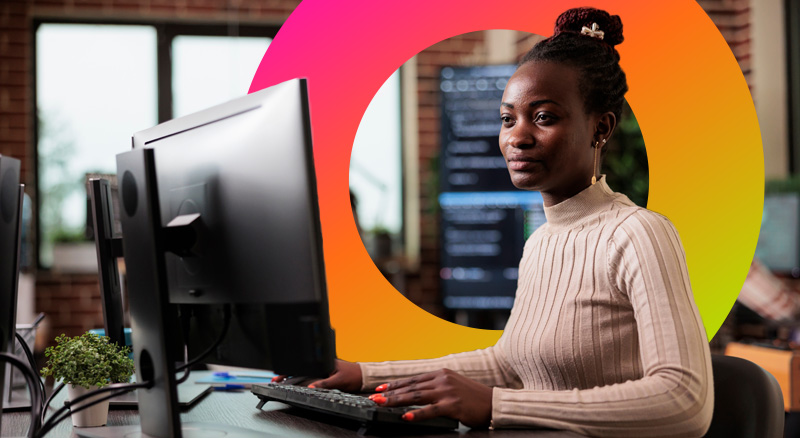 A woman uses a desktop computer