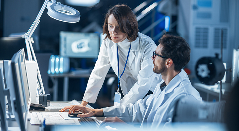 A group of doctors collaboratively examining a computer screen, engaged in discussion and analysis of medical data