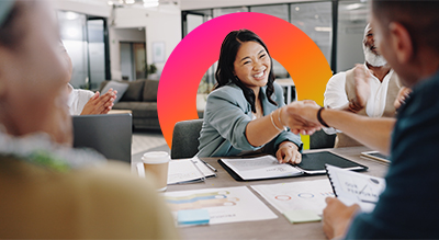 A diverse group of professionals shaking hands during a meeting, symbolizing collaboration and agreement