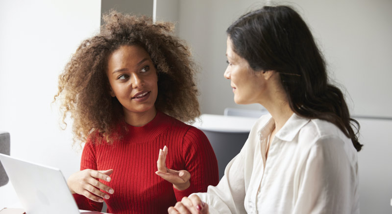 Two women meeting and talking