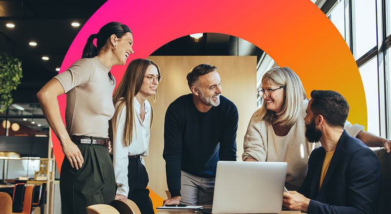 Group of 5 employees review project on laptop