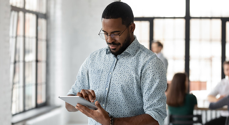 A person holding a tablet in an office environment